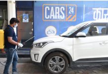 A Cars24 employee sanitises a used car | cars24.com