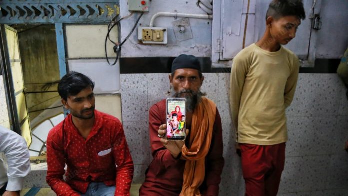 Tasleem A relative holds up a photo of Tasleem Ali's family that lives in UP's Hardoi. A video of the bangle-seller being beaten up has gone viral. Ali is accused of molesting a girl, a charge his family denies | Manisha Mondal | ThePrint