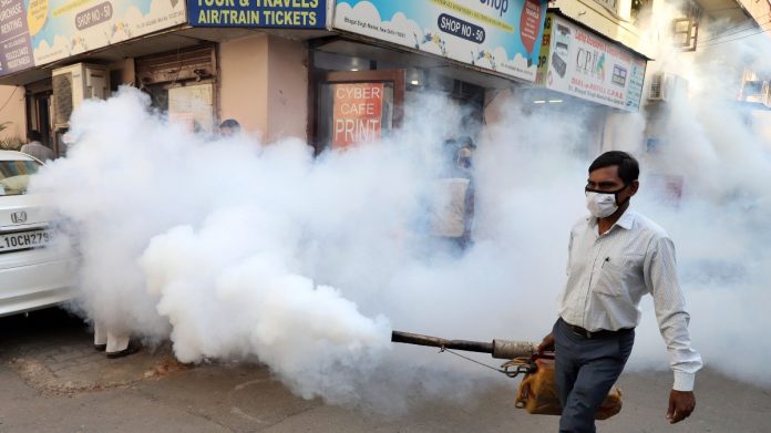A worker fumigates the streets in an attempt to contain the dengue outbreak, at Gole market, in New Delhi on 28 October 2021 | ANI photo A worker fumigates the streets in an attempt to contain the dengue outbreak, at Gole market, in New Delhi on 28 October 2021 | ANI photo
