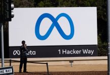 A visitor takes photographs in front of signage at Meta Platforms headquarters in Menlo Park, California, on 29 October 2021 | Photographer: Nick Otto | Bloomberg