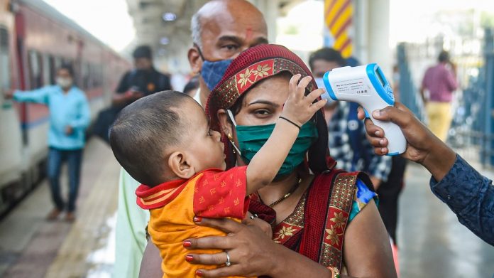 A BMC health worker conducts thermal screening of outstation passengers for Covid-19 testing at Dadar Railway Station in Mumbai, on 17 November 2021 | PTI A BMC health worker conducts thermal screening of outstation passengers for Covid-19 testing at Dadar Railway Station in Mumbai, on 17 November 2021 | PTI